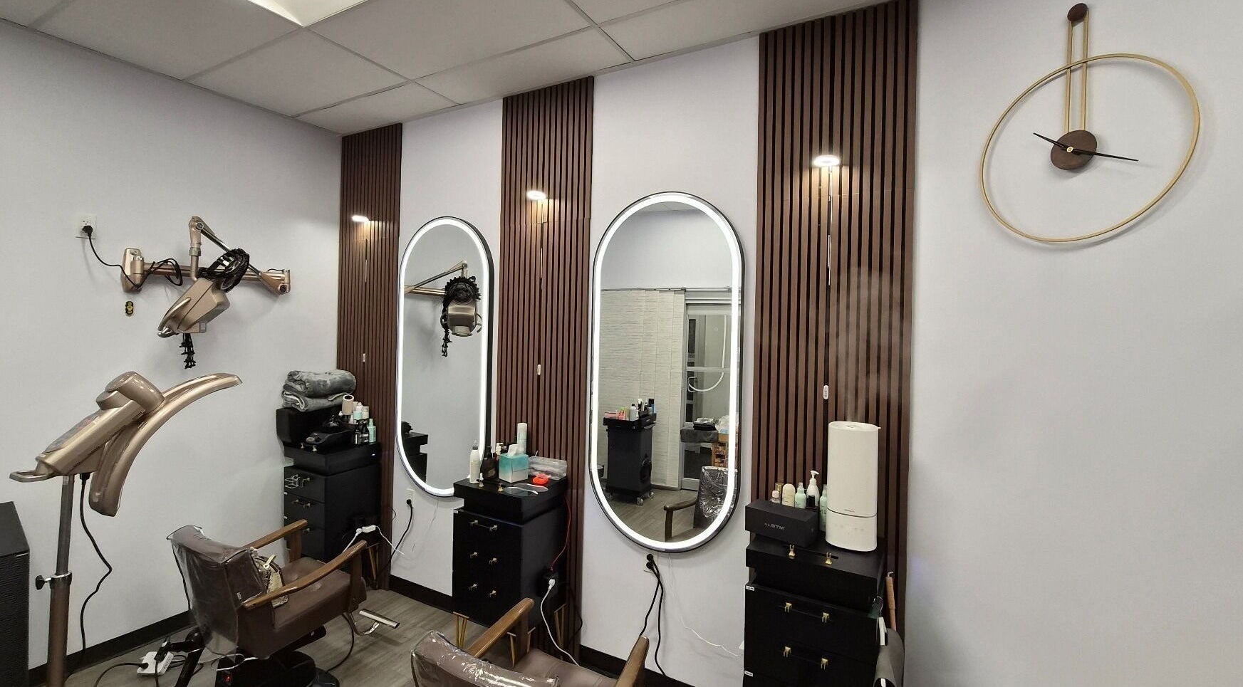 Modern salon interior at One Hair, La Habra, California, US, with sleek styling stations and decor.