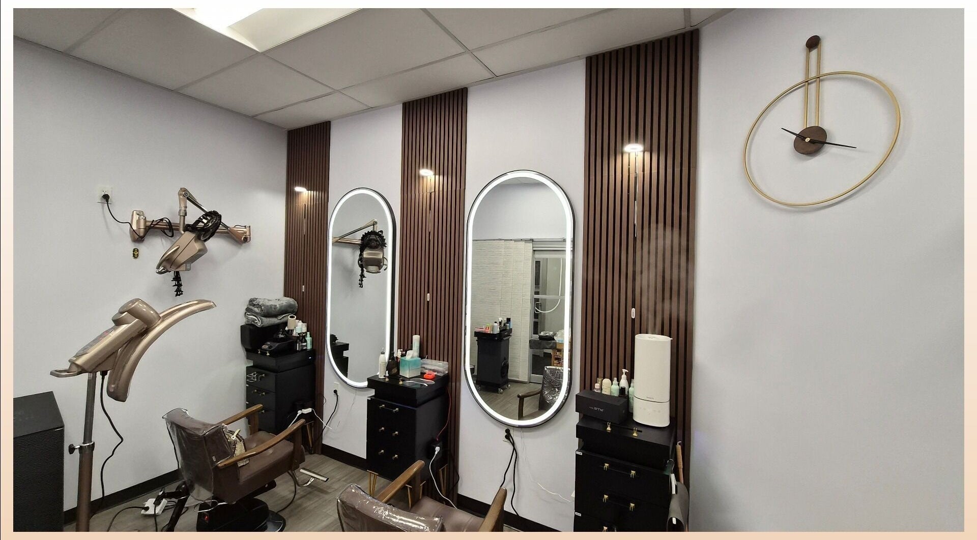 Modern salon interior at One Hair, La Habra, California, US, featuring sleek chairs and stylish wall decor.