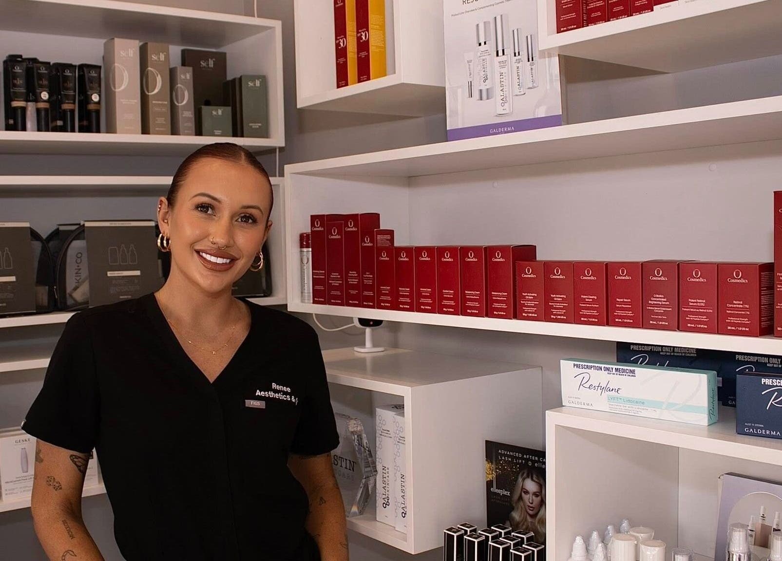 Smiling staff at Aesthetics and Co. stands beside skincare shelves in Melbourne, Victoria, AU.