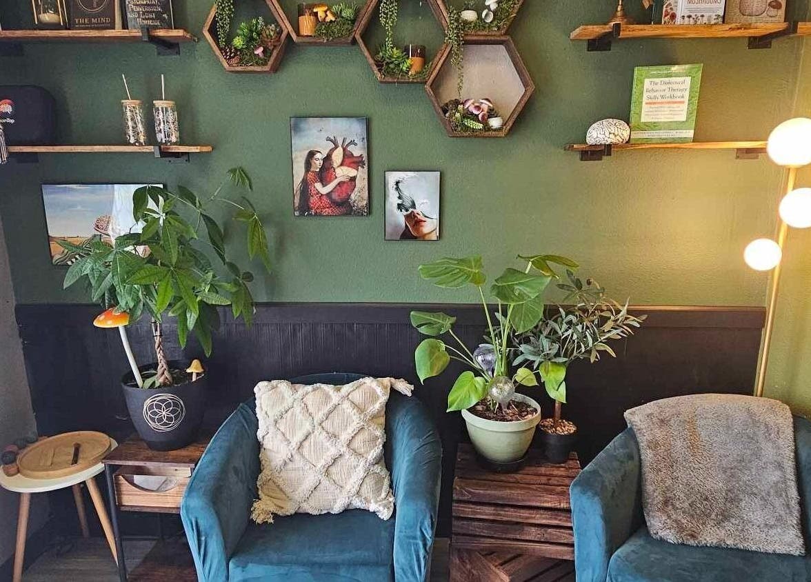 Haven Mind Body Collective & Haven Counseling cozy green lounge in Longview, Washington, US with plants and art.