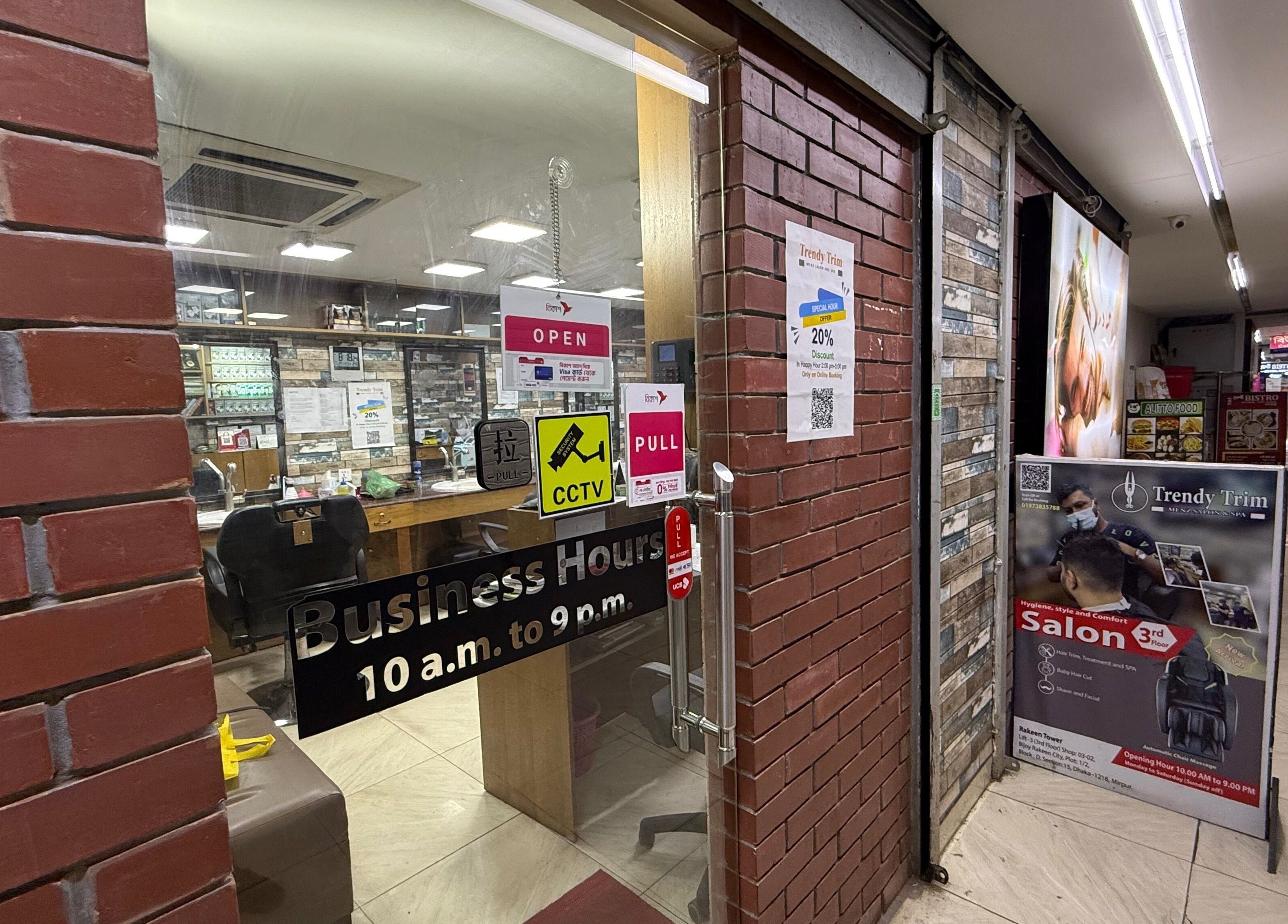 Trendy Trim entry showing glass door signage and business hours in Dhaka, Dhaka Division, BD.