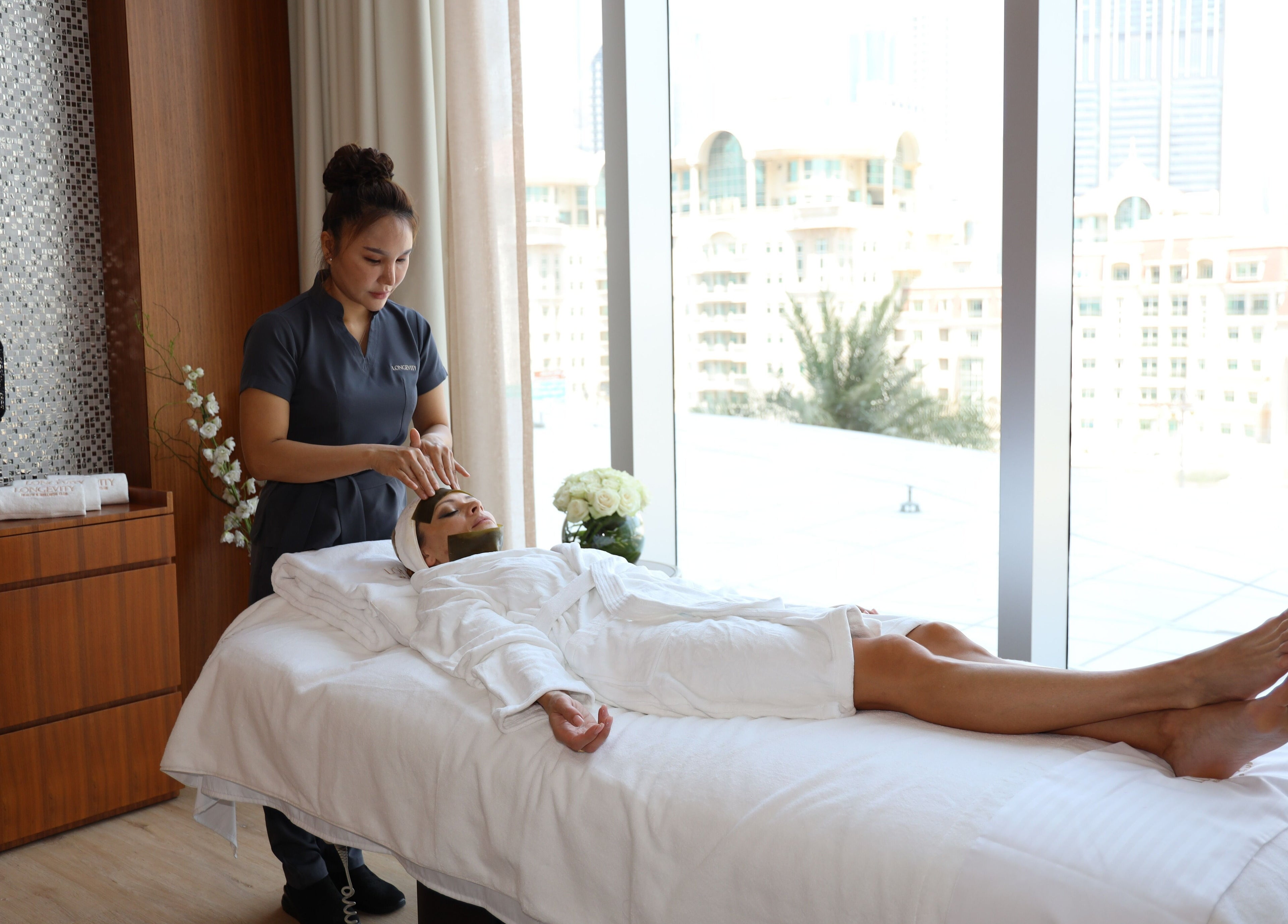 Relaxing massage session at Longevity Health and Wellness Club, دبي, دبي, AE with city view.
