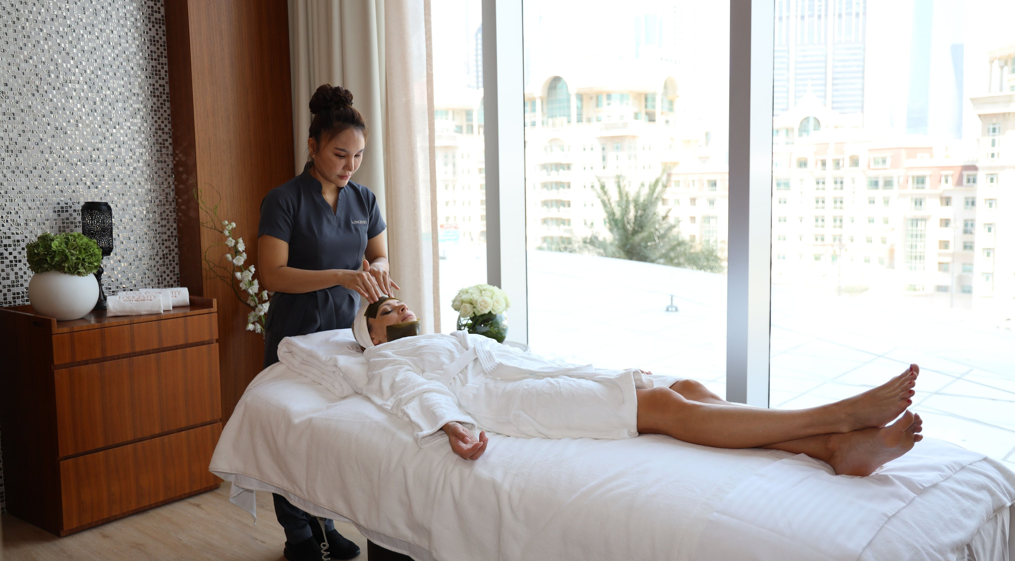 Relaxing massage session at Longevity Health and Wellness Club, دبي, دبي, AE with city view.