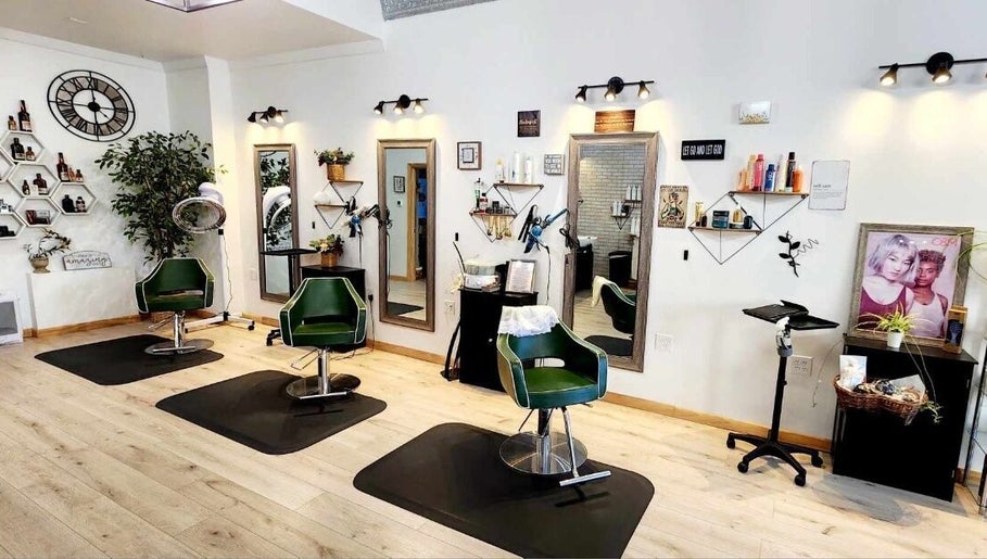 Stylish salon interior at Look Wellness Studio, Quincy, Illinois, US with modern decor and green chairs.