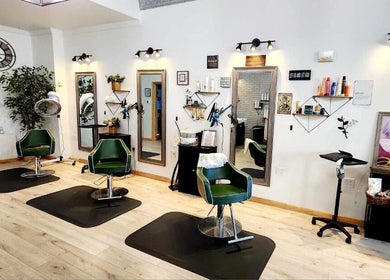 Stylish salon interior at Look Wellness Studio, Quincy, Illinois, US with modern decor and green chairs.