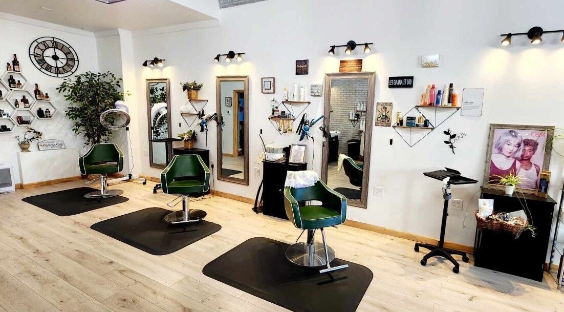 Stylish salon interior at Look Wellness Studio, Quincy, Illinois, US with modern decor and green chairs.
