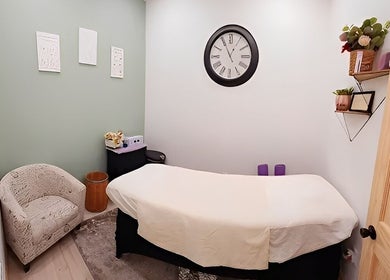 Cozy massage room at Look Wellness Studio in Quincy, Illinois, US with a soft bed and soothing decor.