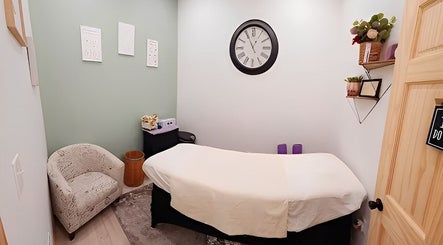 Cozy massage room at Look Wellness Studio in Quincy, Illinois, US with a soft bed and soothing decor.