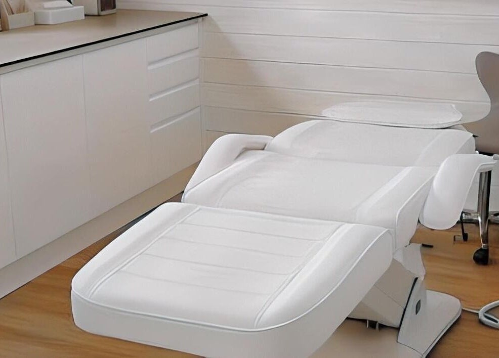Luxurious treatment room at NC Wellbeing in Meopham, England, GB, featuring a modern white therapy chair.