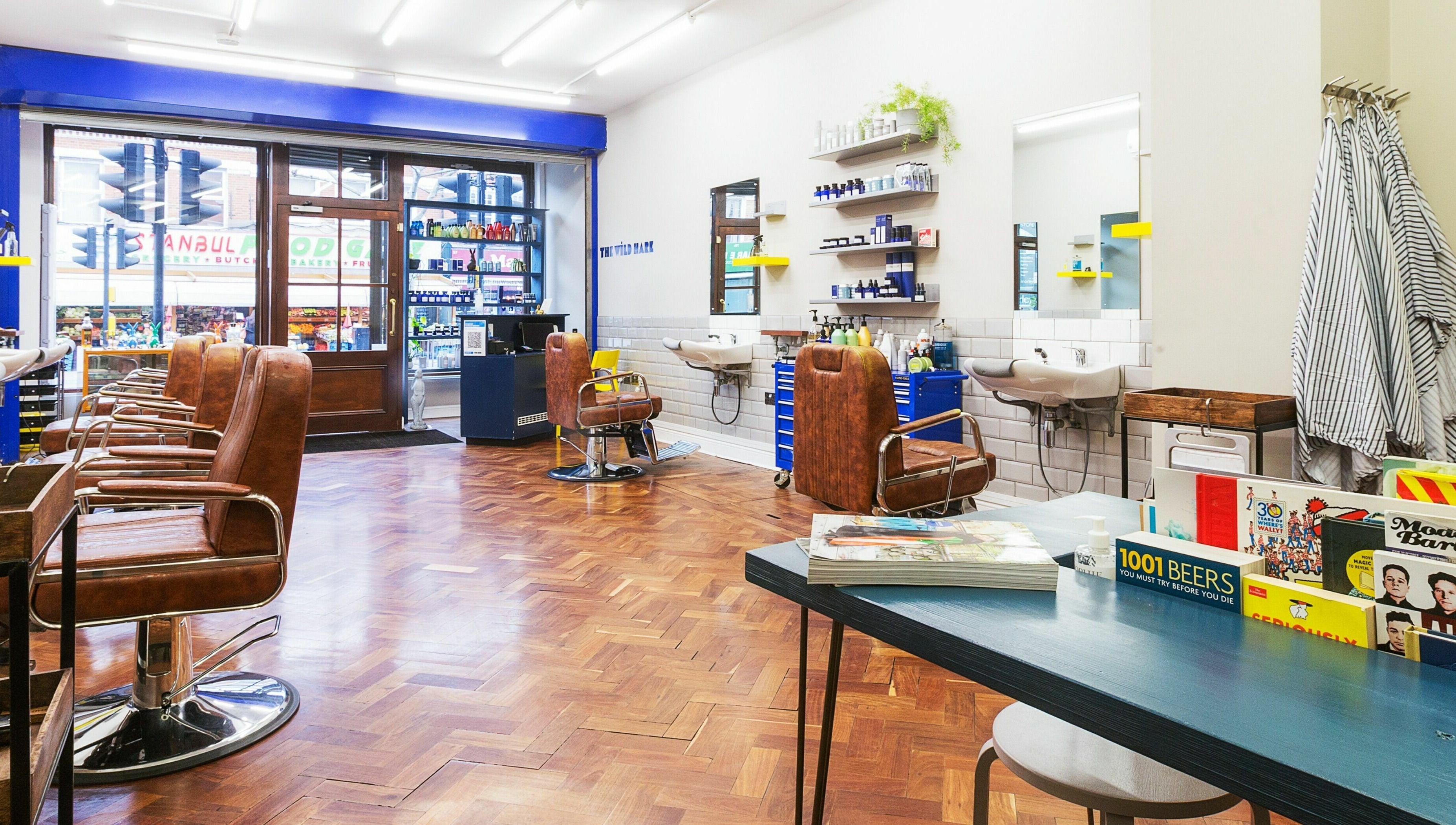 Modern salon interior at The Wild Hare, London, England, GB with sleek design and leather chairs.