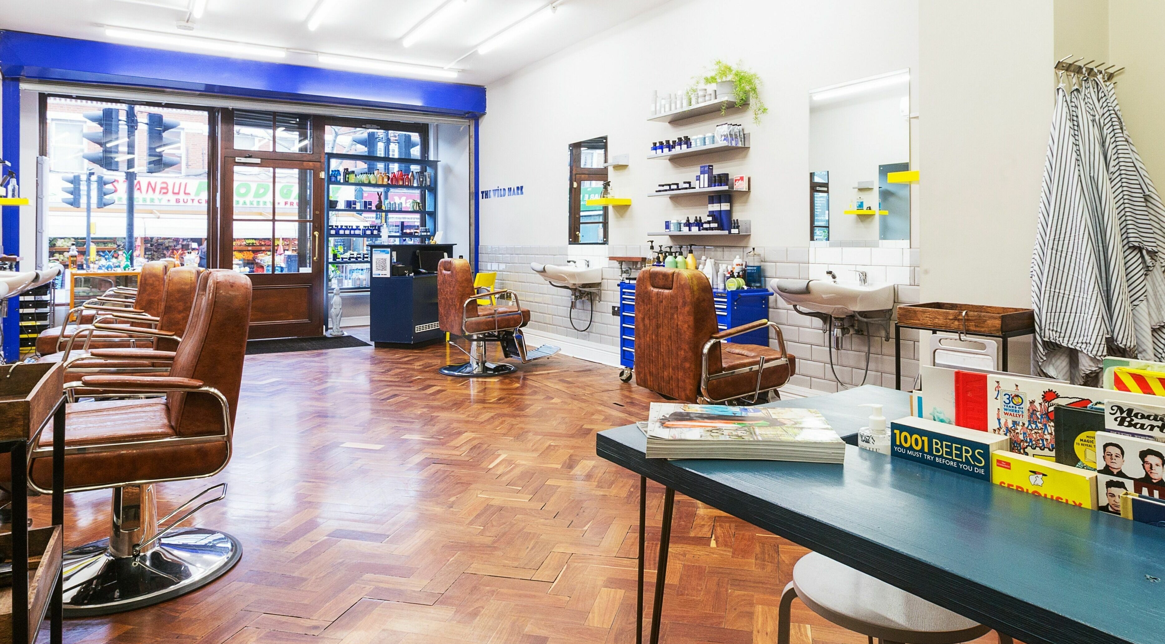 Modern salon interior at The Wild Hare, London, England, GB with sleek design and leather chairs.