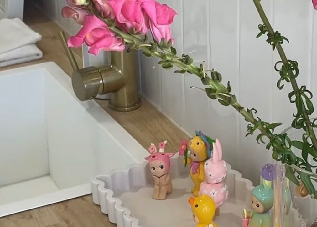 Elegant vanity with pink flowers and figurines at The Gel Bar, Currumbin Waters, Queensland, AU.
