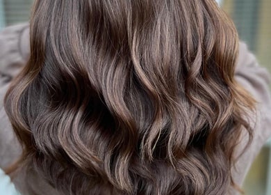 Rich brown wavy hairstyle crafted at Laura Waterworth Hair, Dunmurry, Northern Ireland, GB.