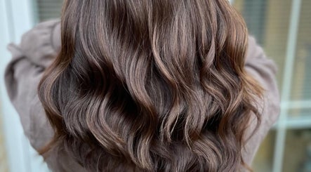Rich brown wavy hairstyle crafted at Laura Waterworth Hair, Dunmurry, Northern Ireland, GB.