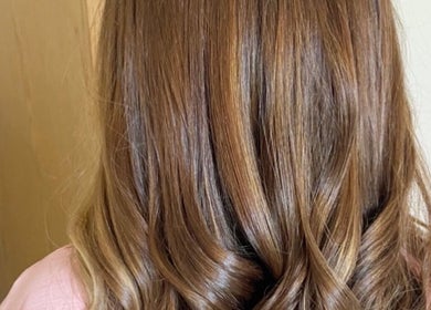 Stylish curled hairstyle at Laura Waterworth Hair, Dunmurry, Northern Ireland, GB.