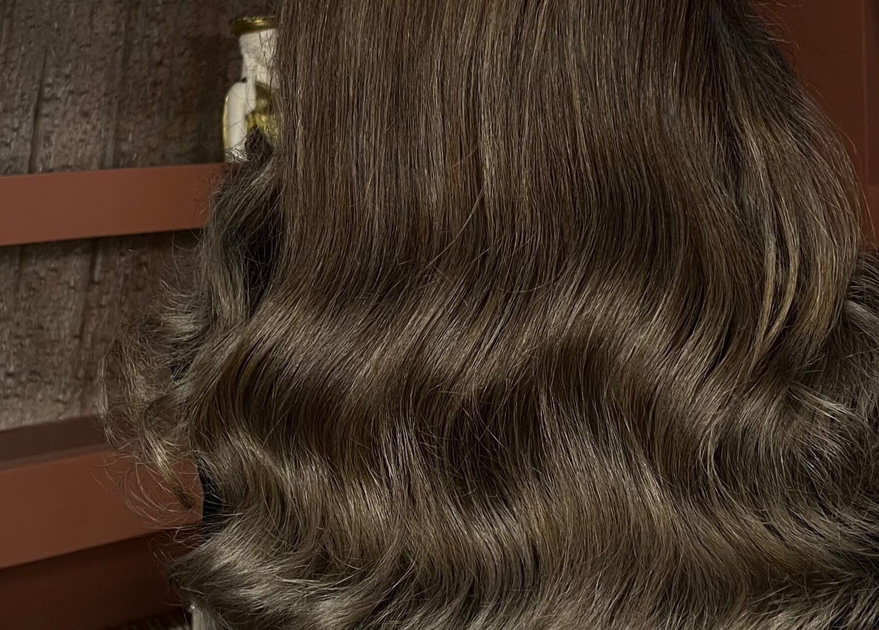 Lustrous wavy brown hair styled at Madame Oh La Laa, Al Khobar, SA, showcasing expert salon services.