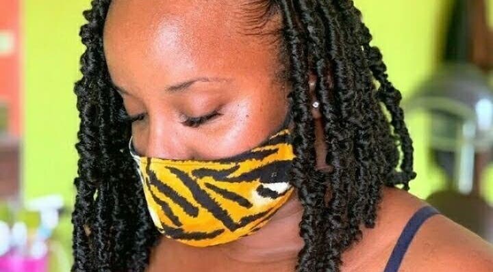 Client with braided hairstyle at Splash Beauty Lounge, Blades, Saint Philip, BB with vibrant decor.