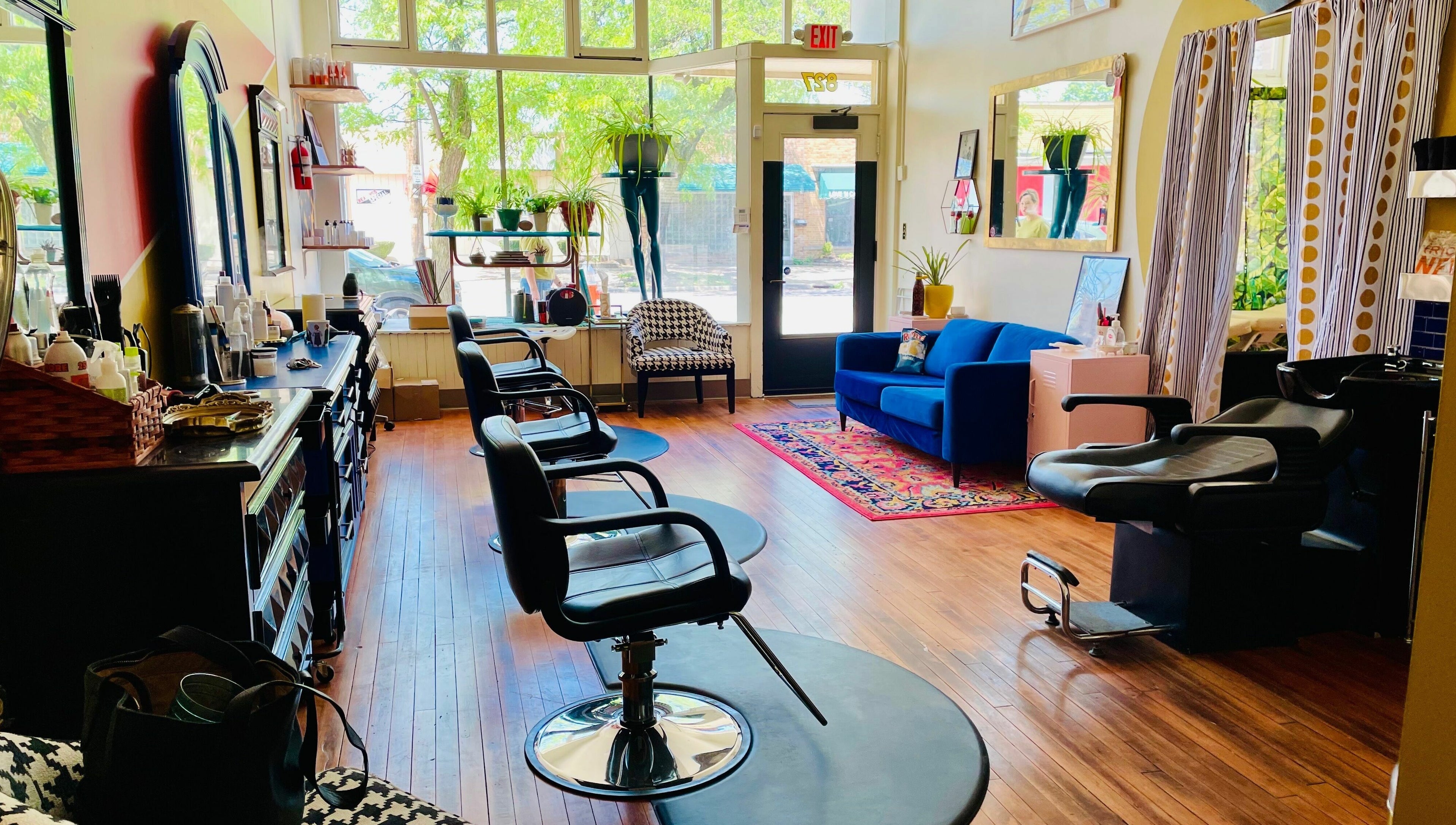 Chic interior of Pretty Things Salon in Cleveland, Ohio, US, featuring styling chairs and a plush seating area.