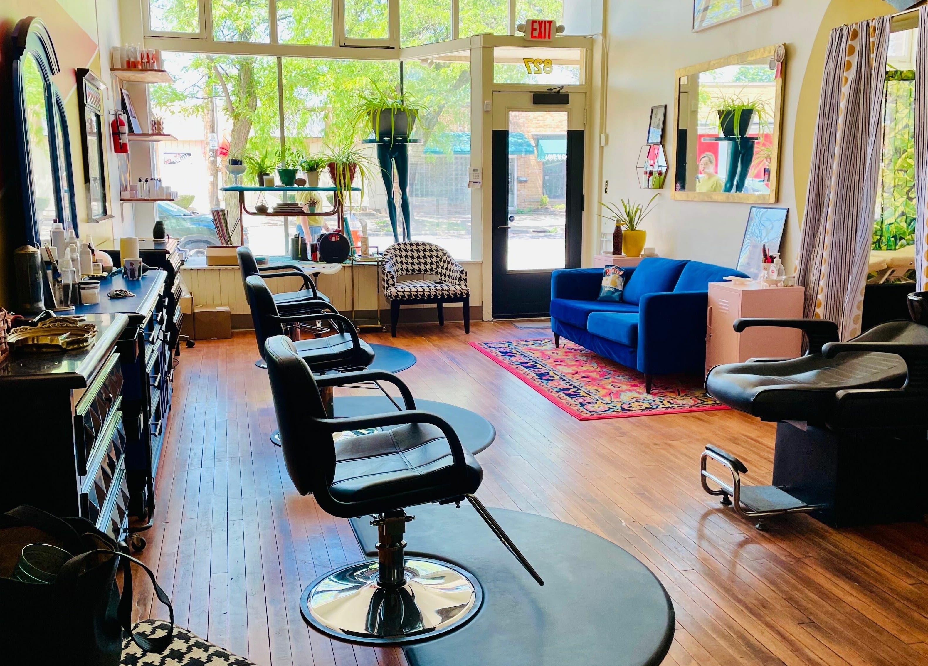 Chic interior of Pretty Things Salon in Cleveland, Ohio, US, featuring styling chairs and a plush seating area.