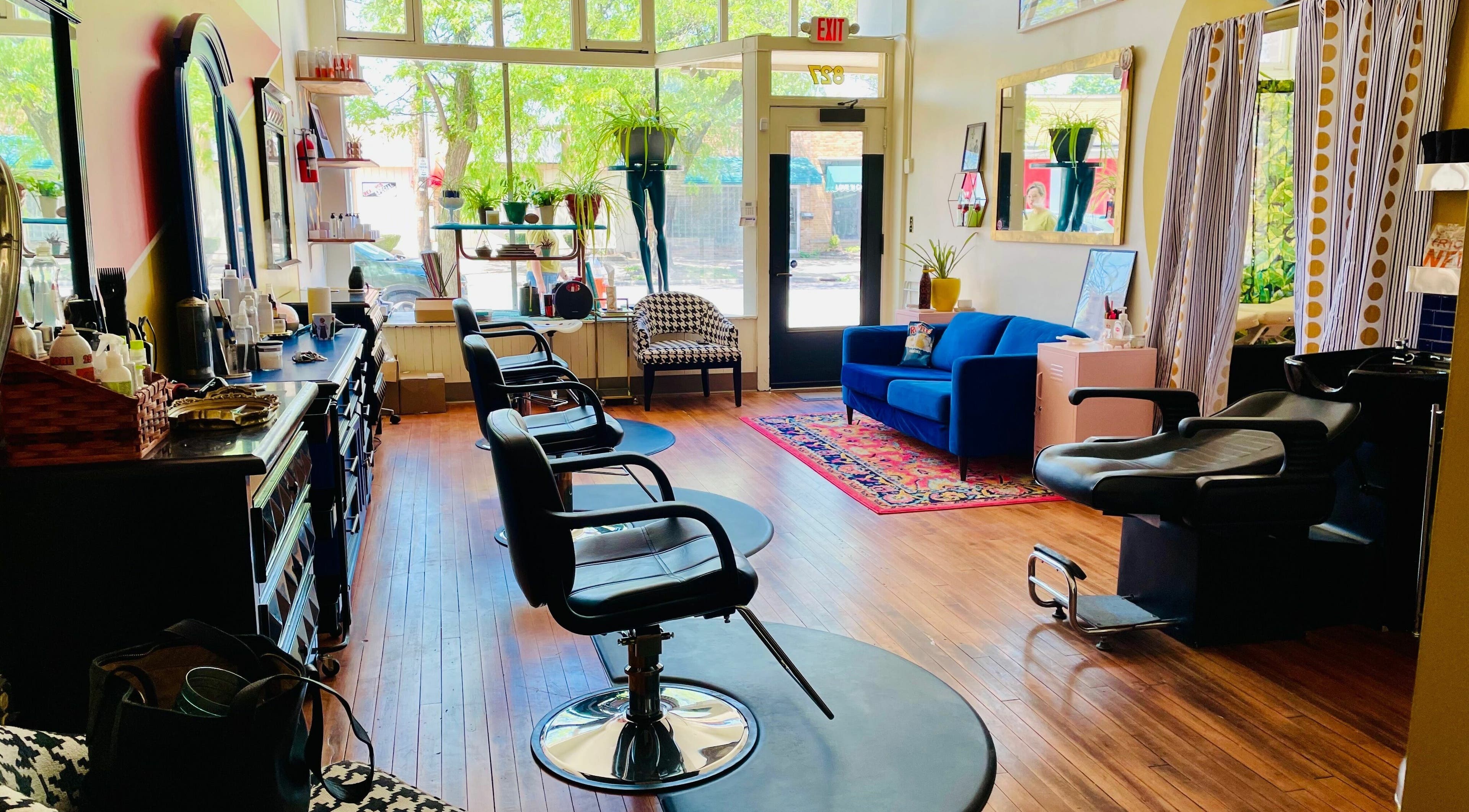 Chic interior of Pretty Things Salon in Cleveland, Ohio, US, featuring styling chairs and a plush seating area.