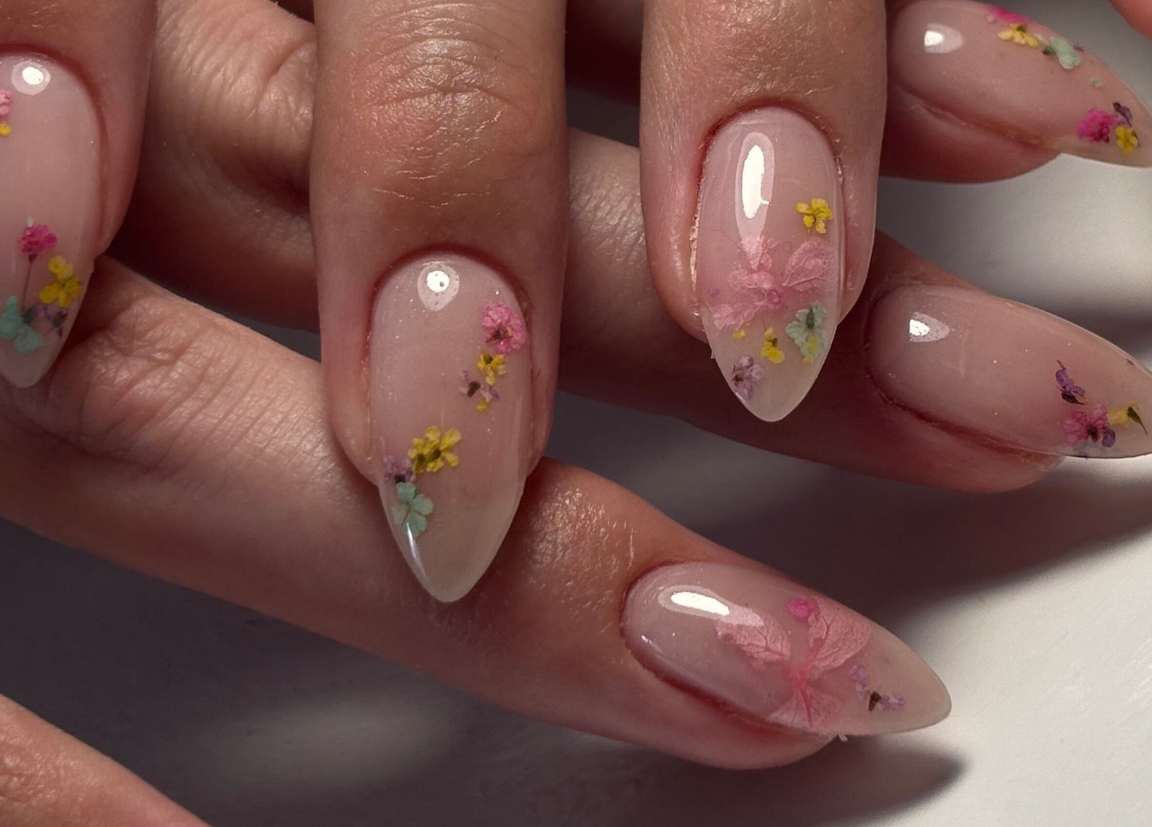 Floral nail art at Sterling Co. in New Plymouth, Taranaki, NZ, showcasing intricate, colorful designs.