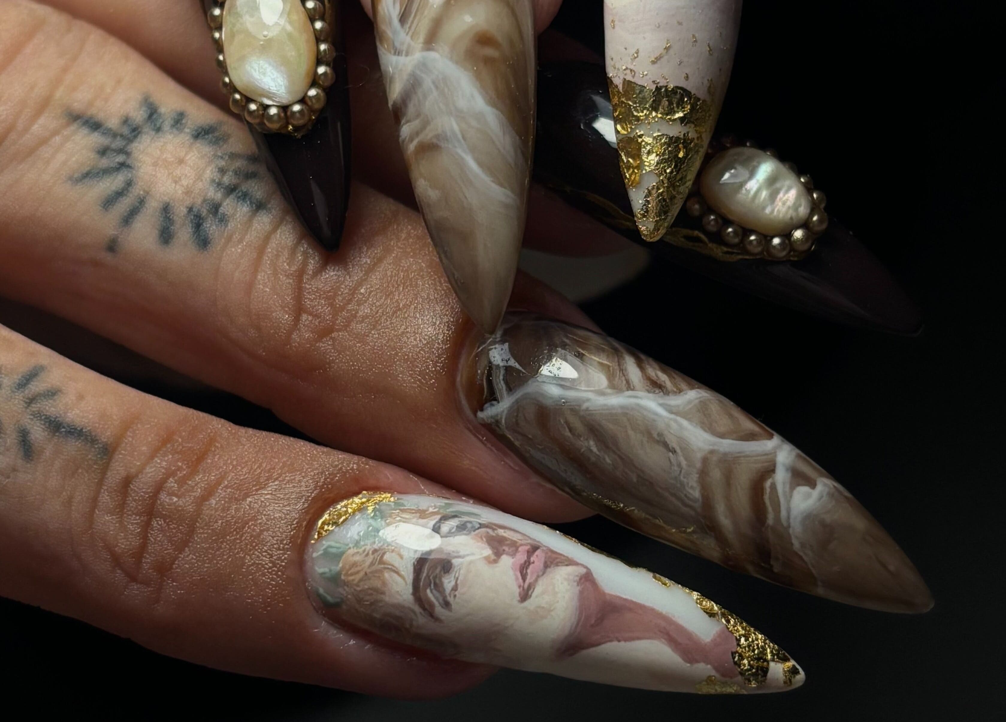 Exquisite artistic nail designs at Sterling Co., New Plymouth, Taranaki, NZ, featuring marble and portrait styles.