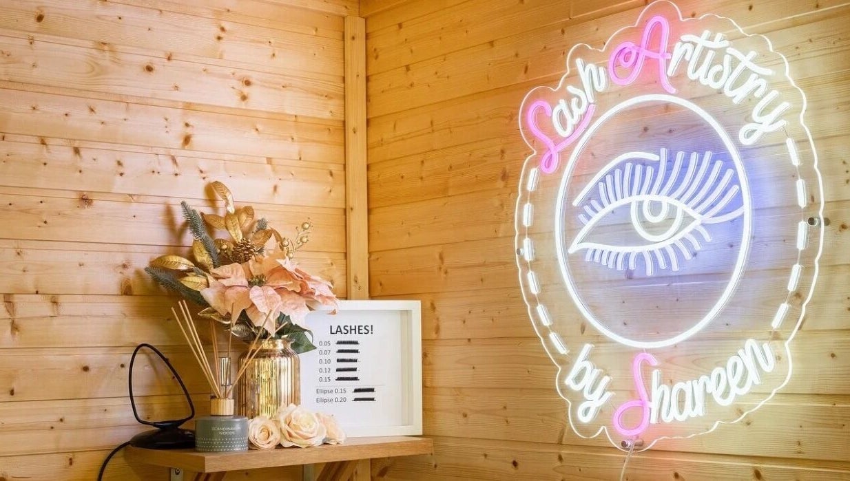 Neon sign and decor at Lashes by Shareen, Kettering, England, GB. Cozy ambiance with floral accents.