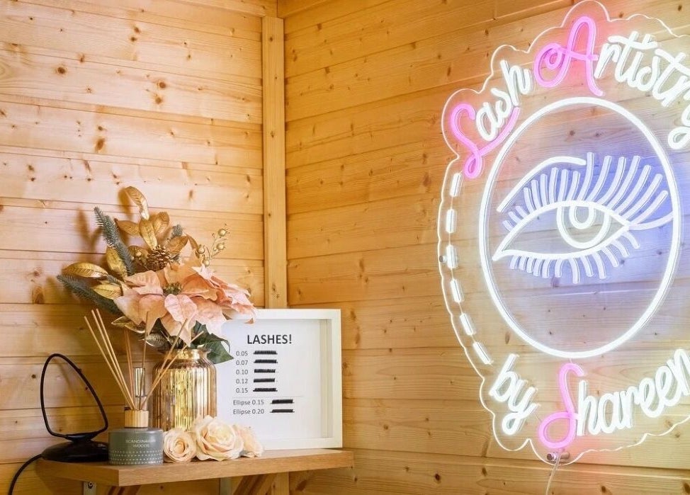 Neon sign and decor at Lashes by Shareen, Kettering, England, GB. Cozy ambiance with floral accents.