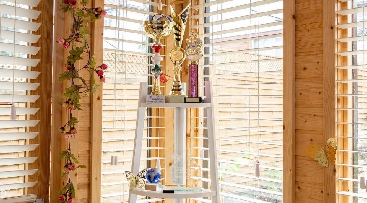 Awards display at Lashes by Shareen, Kettering, England, GB with natural light and floral decor.