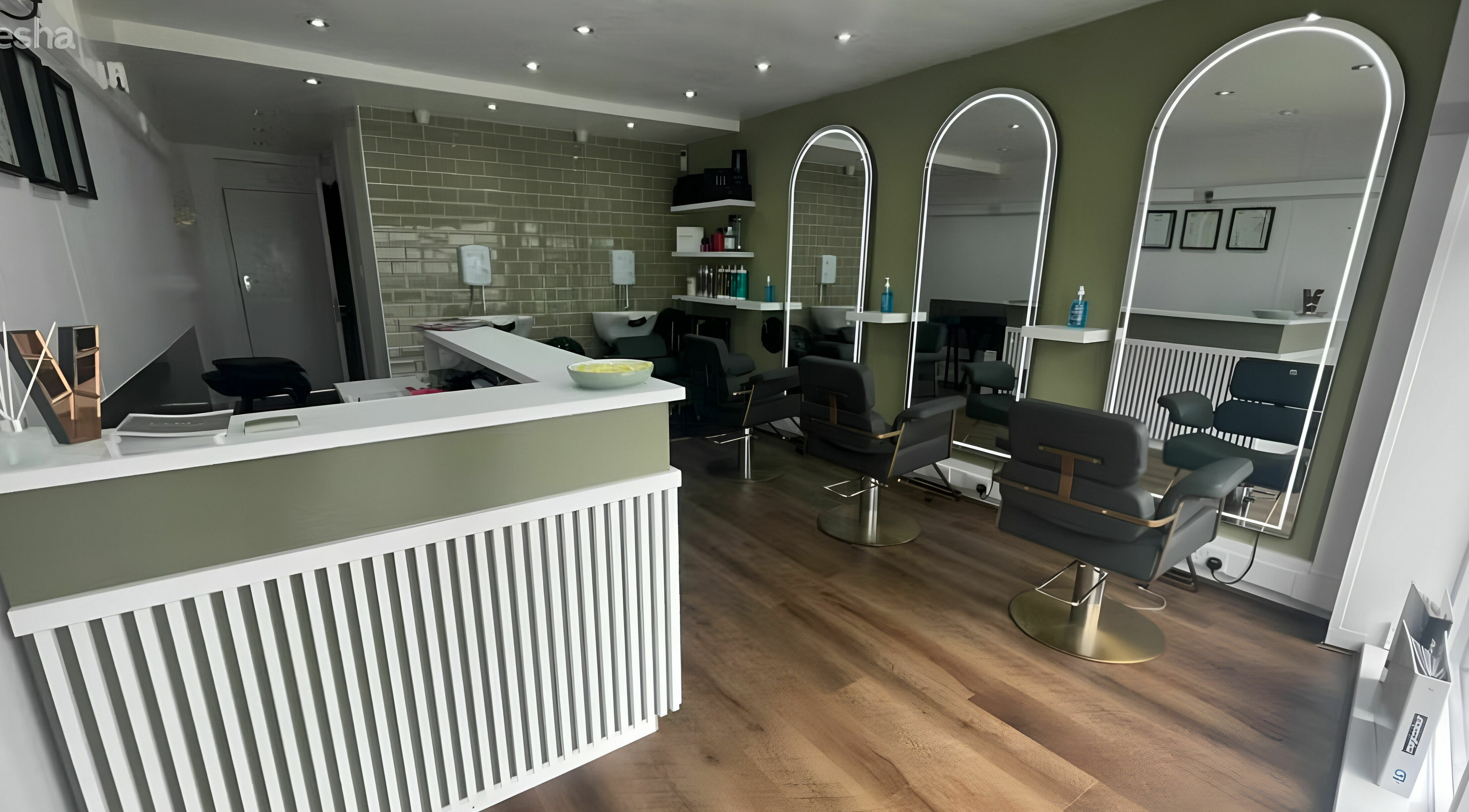 Modern interior of Verde Hair Salon in Leeds, England, GB, featuring stylish chairs and illuminated mirrors.