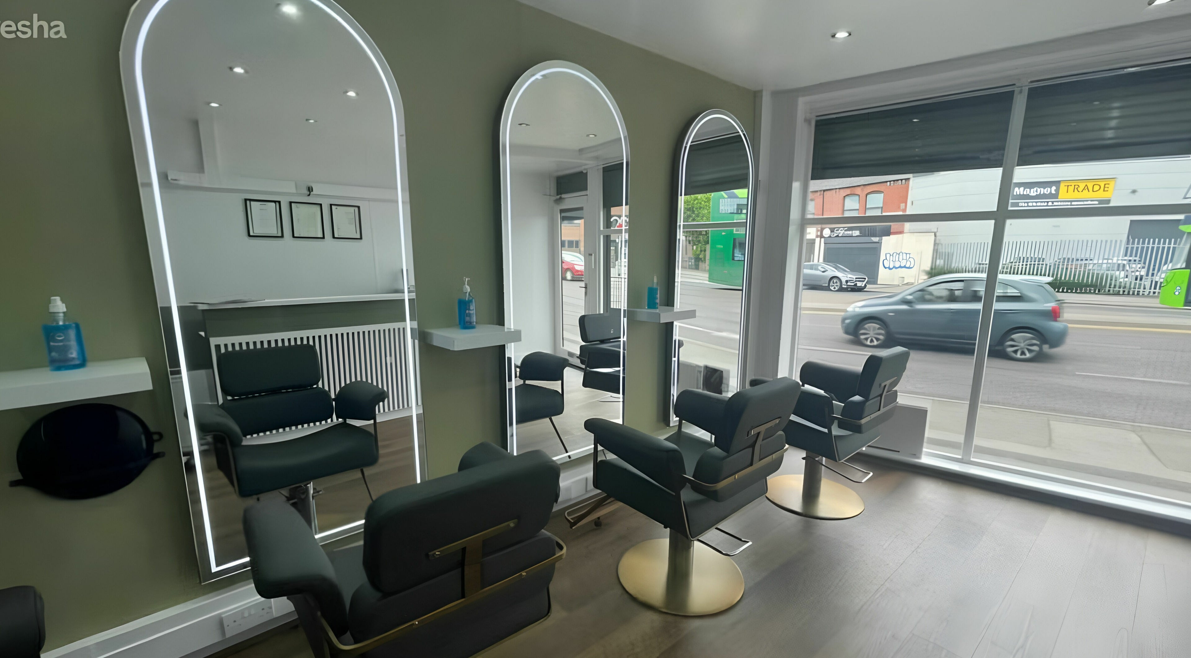 Elegant salon mirrors at Verde Hair Salon, Leeds, England, GB with modern chairs and decor.