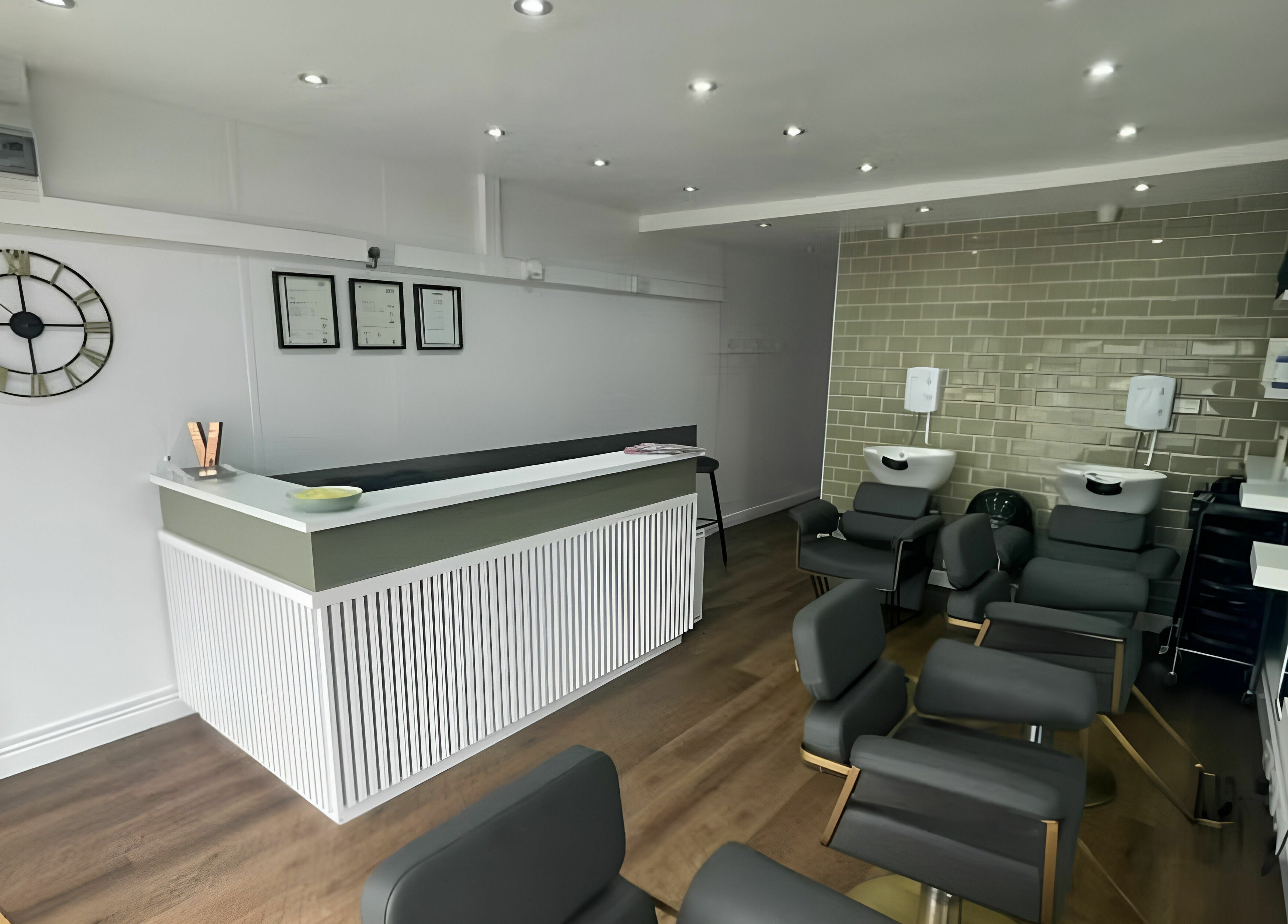 Modern interior of Verde Hair Salon in Leeds, England, GB, featuring sleek chairs and stylish decor.
