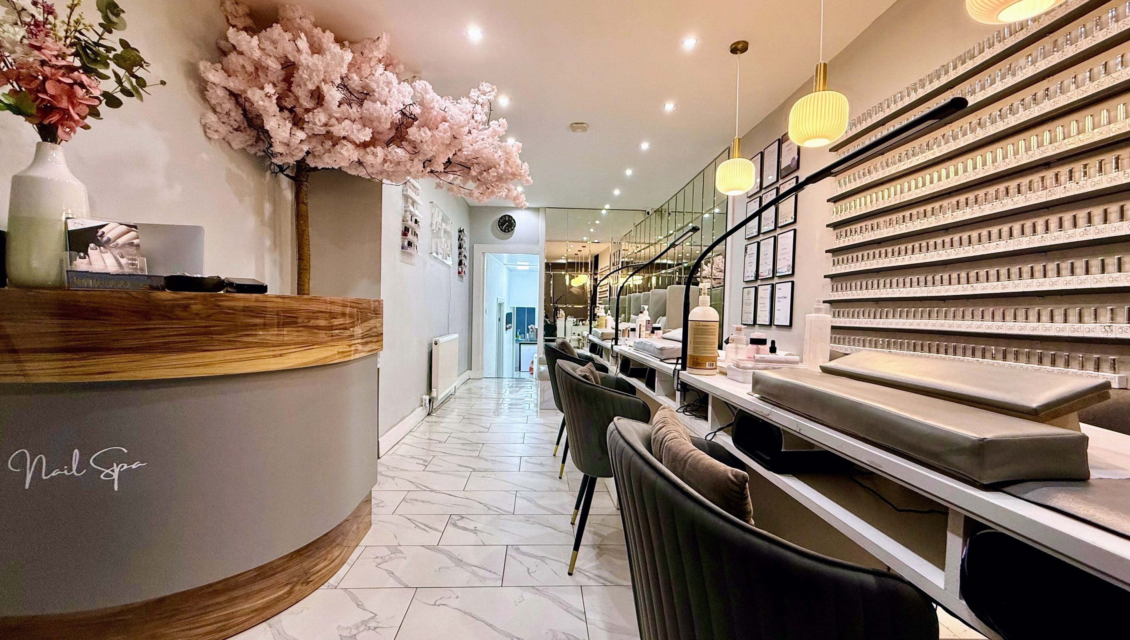 Elegant interior of Nail Spa in Penarth, Wales, GB, showcasing manicure stations and chic decor.