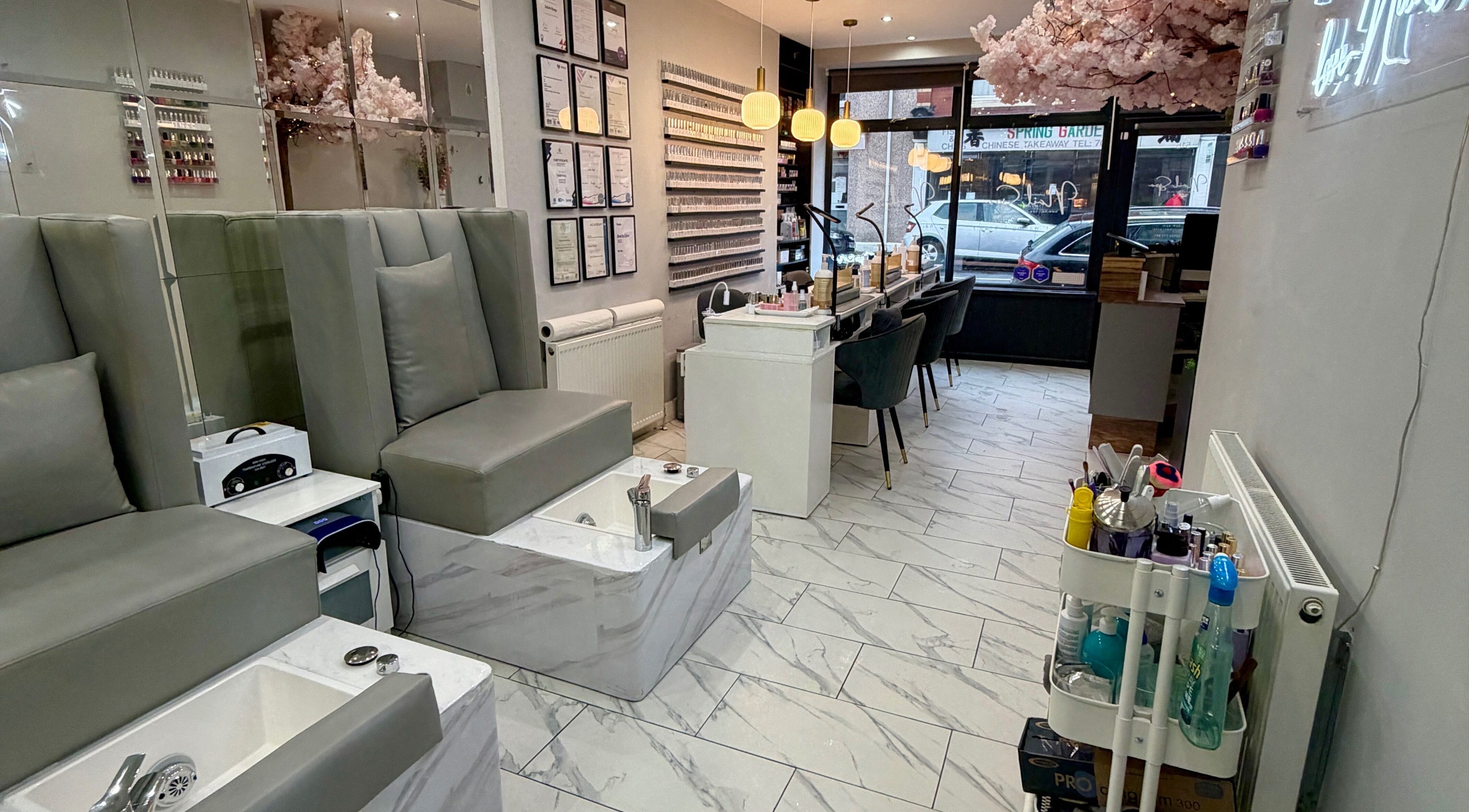 Chic interior of Nail Spa in Penarth, Wales, GB featuring plush seating and modern decor.