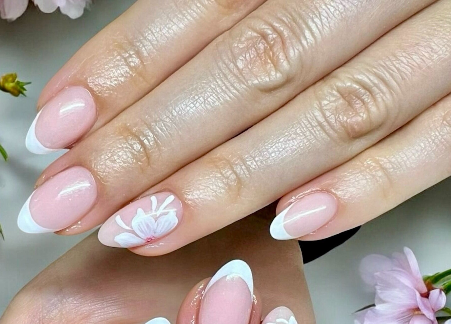 Elegant floral nail art at Nail Spa, Penarth, Wales, GB, showcasing a soft pink and white design.
