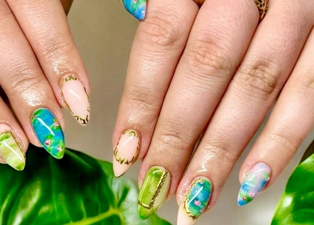 Vibrant tropical nail art at Nail Spa, Penarth, Wales, GB, showcasing exquisite green and blue designs.