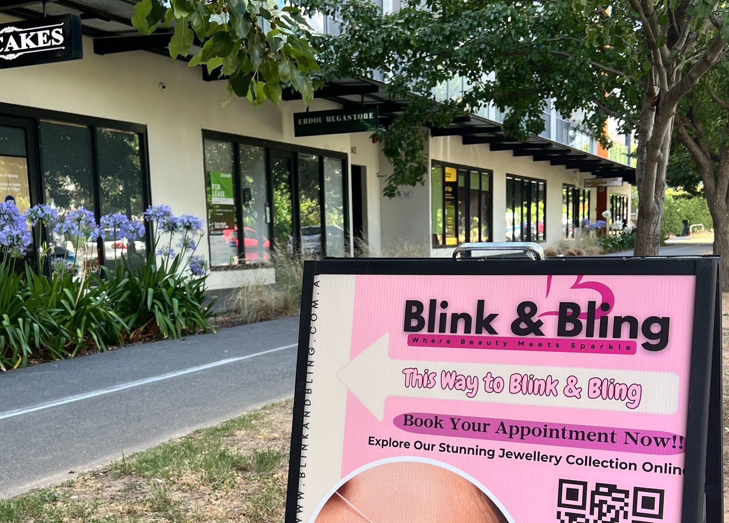 Charming storefront of Blink & Bling in Gungahlin, ACT, AU with inviting signage and blooming flowers.