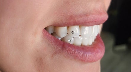 Tooth gems at Tash's Tanning in Beldon, Western Australia, AU, offering unique dental styling.