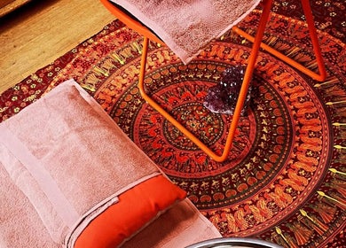 Relaxing decor at Magic Place Massage and Facial Therapy in Bristol, England, GB with warm-colored towels and patterns.