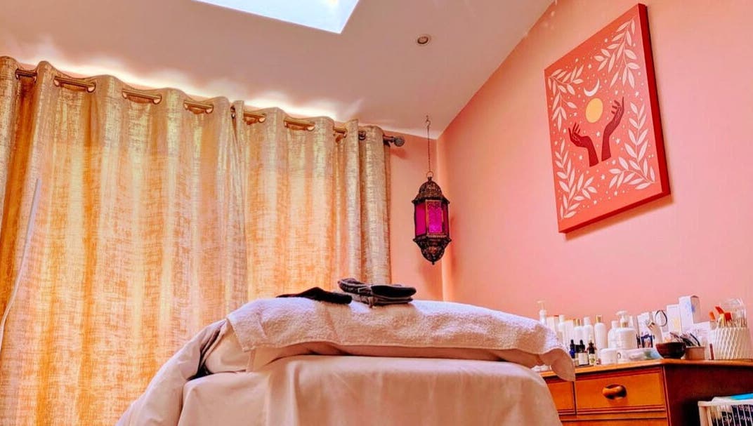 Relaxing massage room at Magic Place Massage and Facial Therapy in Bristol, England, GB with warm decor.