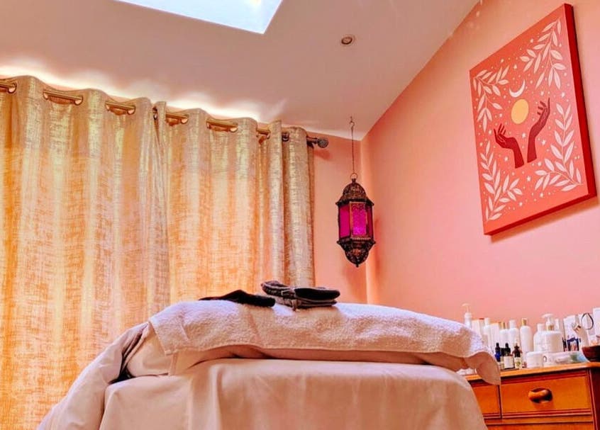 Relaxing massage room at Magic Place Massage and Facial Therapy in Bristol, England, GB with warm decor.