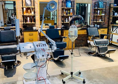 Papito Barbershop in Dubai, AE with modern barber chairs and sleek equipment displayed.