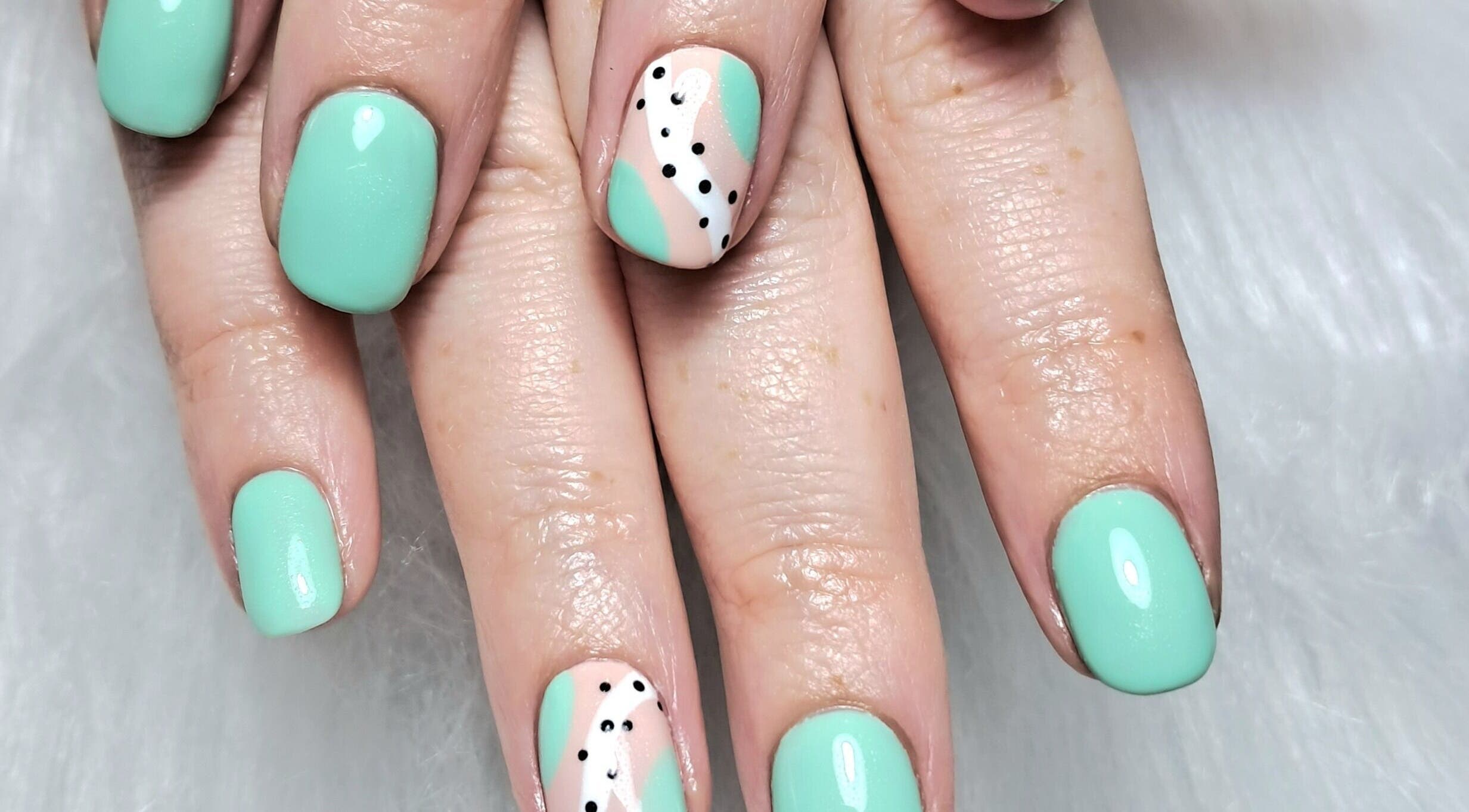 Stylish mint and polka dot nail art at Scratch Pad Nails, Waddington, England, GB.