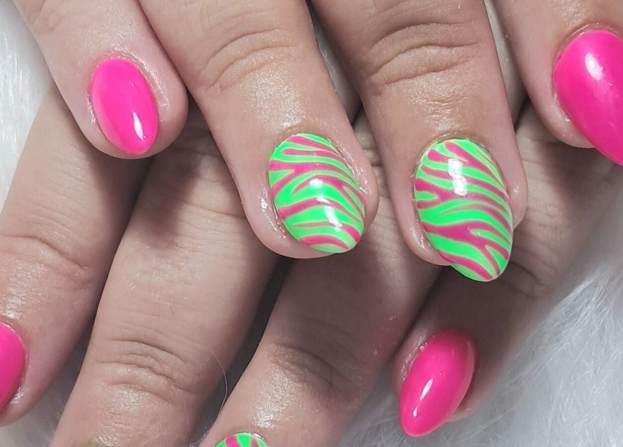 Vibrant neon pink and green swirl nail art at Scratch Pad Nails, Waddington, England, GB.