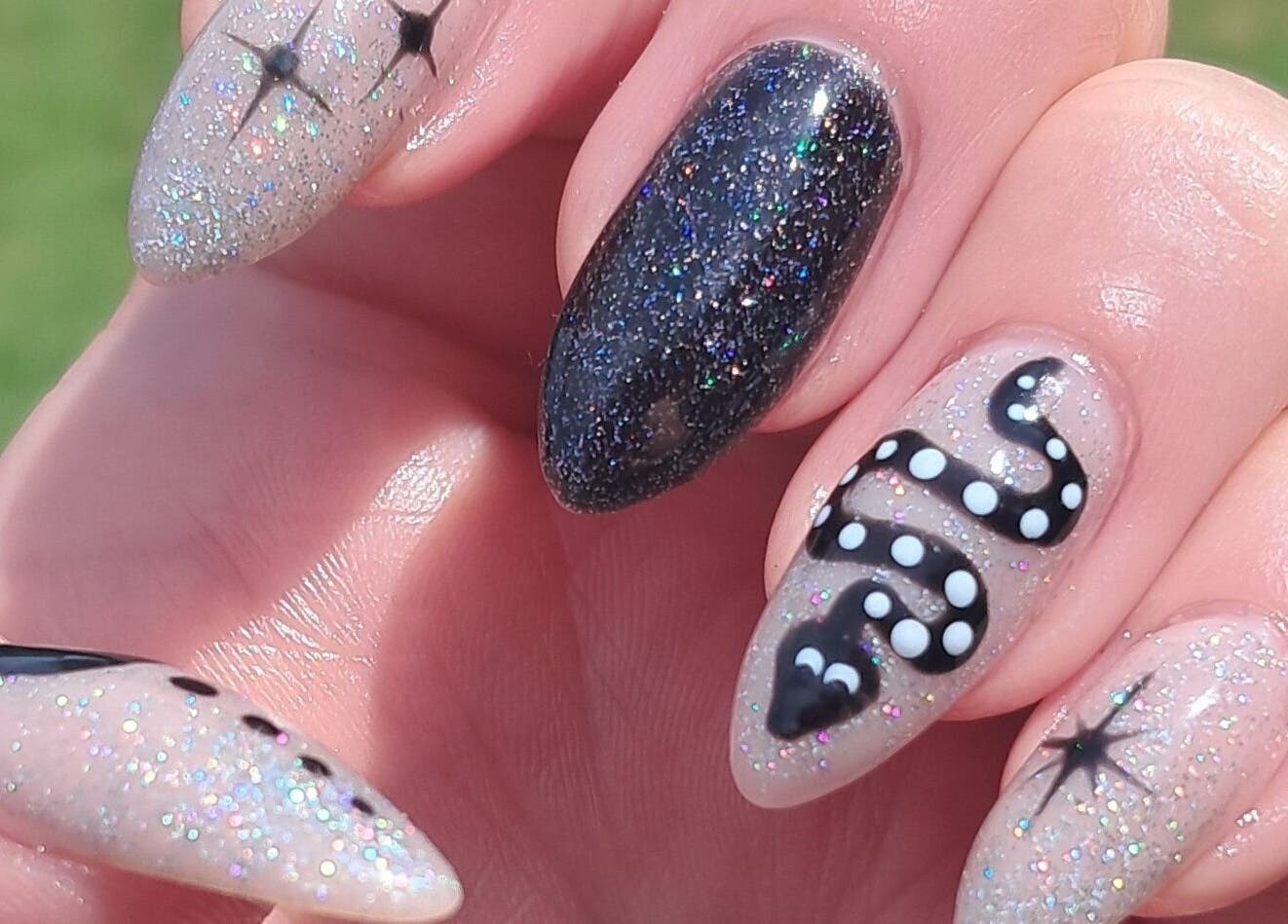 Intricate galaxy-themed nail art at Scratch Pad Nails in Waddington, England, GB showcasing glitter and detailed design.