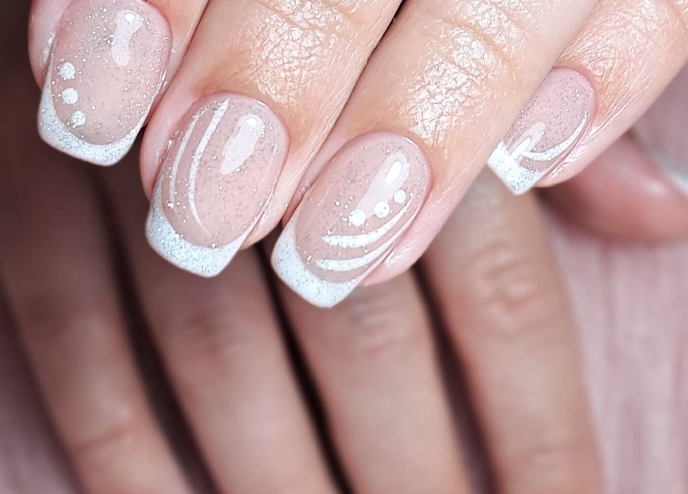 Elegant nail art detail at Scratch Pad Nails, Waddington, England, GB showcasing delicate white designs.