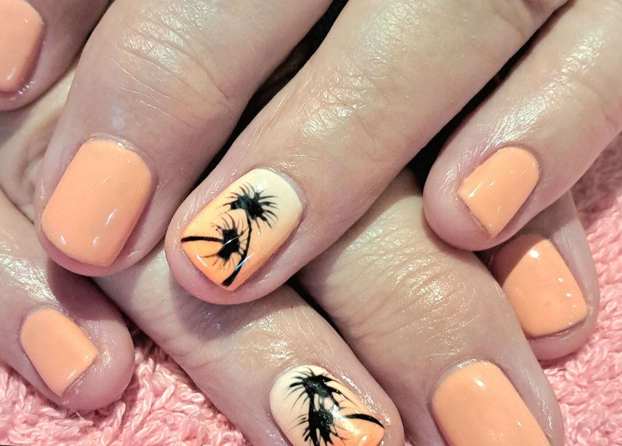 Bright nail art at Scratch Pad Nails, Waddington, England, GB, featuring palm tree designs on orange polish.