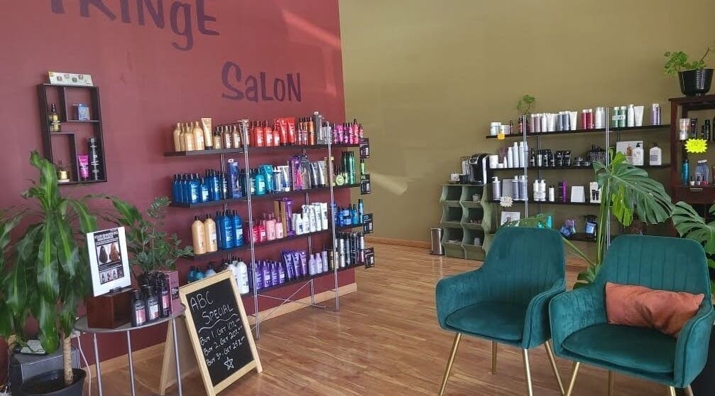 Fringe Salon in Elkhart, Indiana, US, showcasing chic seating and diverse hair care products on wooden shelves.