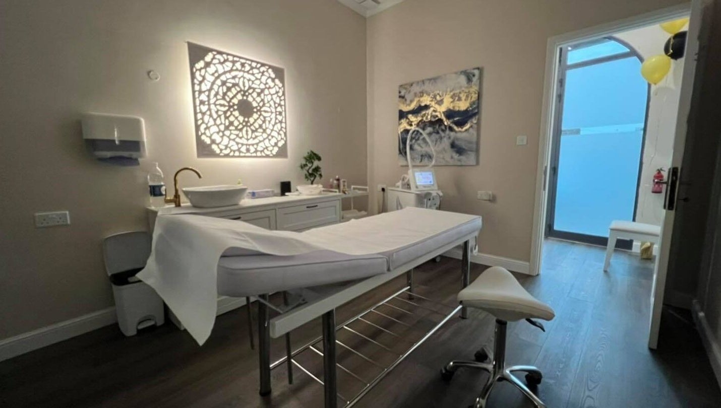 Serene spa treatment room at Total Beauty Malta in Ħal Luqa, MT featuring a massage table and elegant decor.