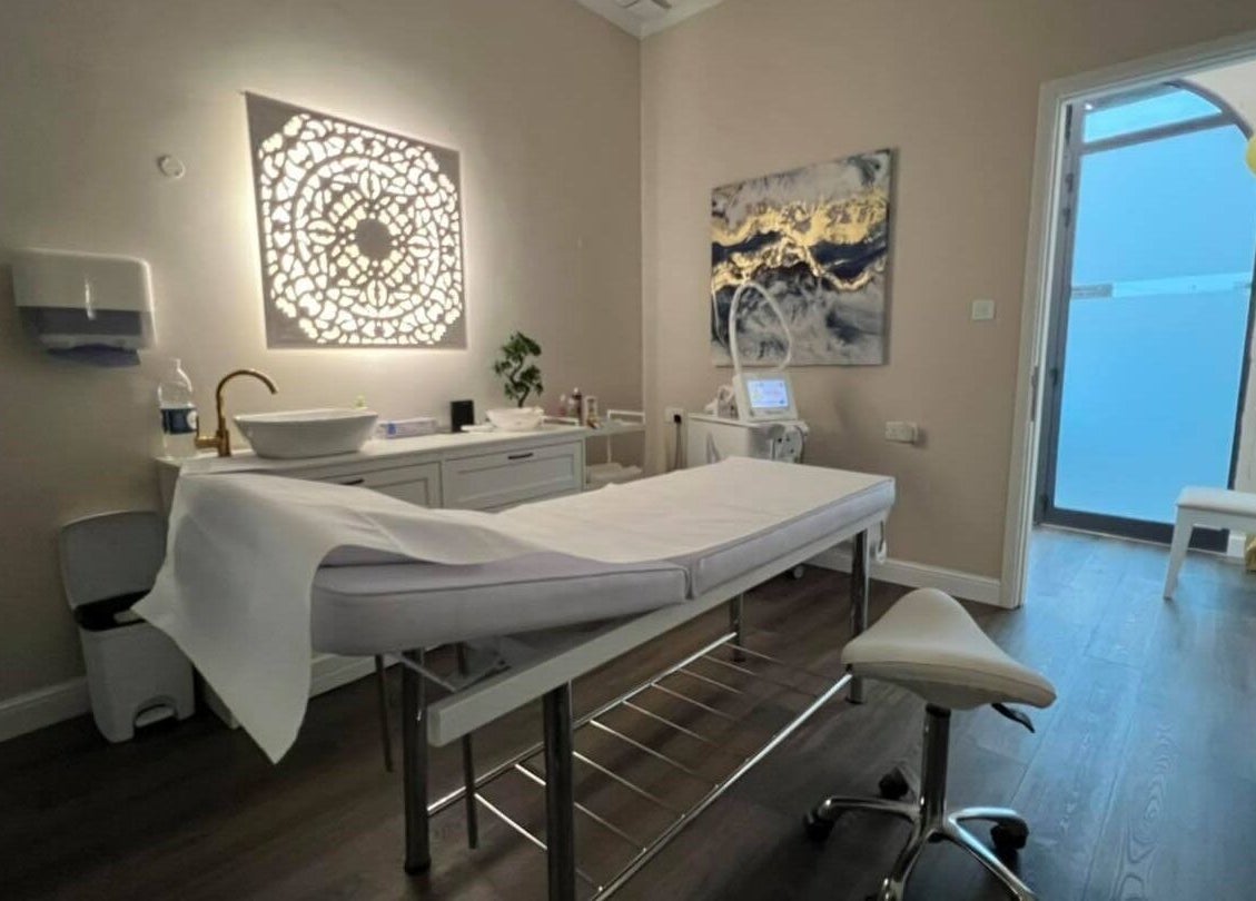 Serene spa treatment room at Total Beauty Malta in Ħal Luqa, MT featuring a massage table and elegant decor.
